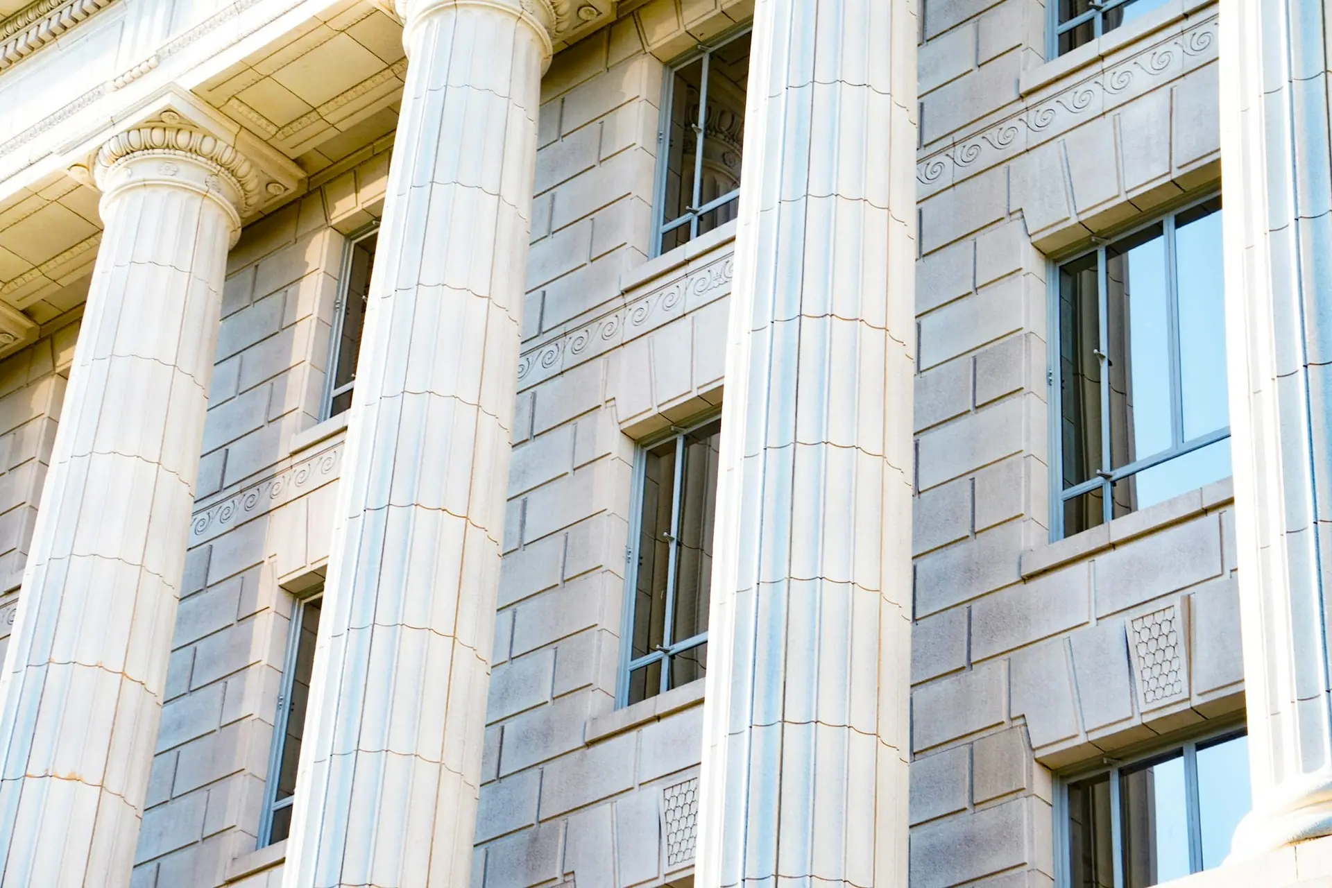 Fluted stone columns on the facade of a classical institutional building